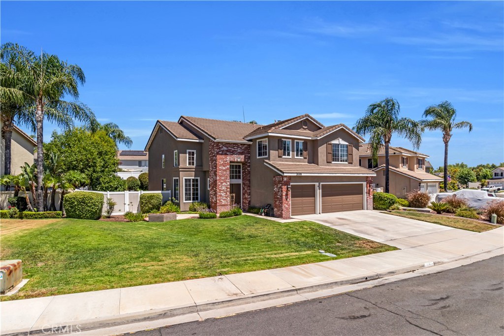 28308 Corte Ocaso Temecula, CA 92592 - Photo 3 of 43 a front view of a house with a garden and yard