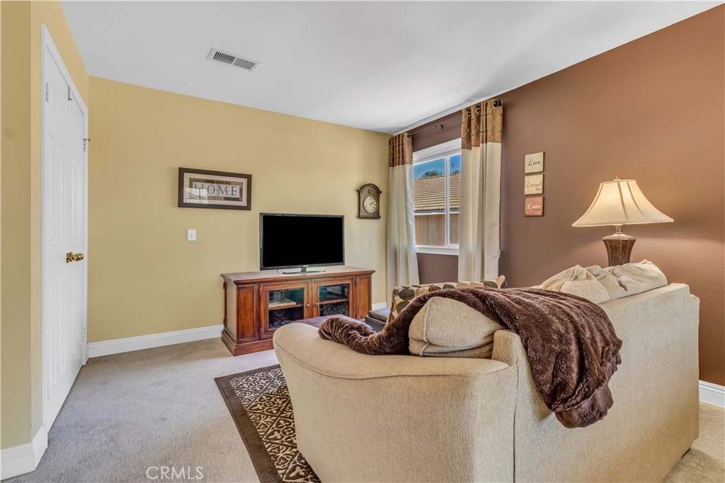 28308 Corte Ocaso Temecula, CA 92592 - Photo 33 of 43 a bedroom with a bed and a flat screen tv