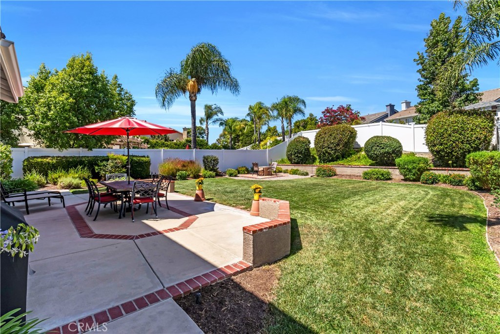 28308 Corte Ocaso Temecula, CA 92592 - Photo 35 of 43 a view of a patio with a table and chairs under an umbrella