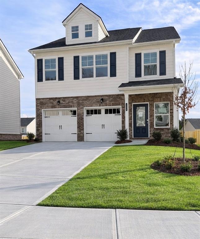 a front view of a house with a yard and garage