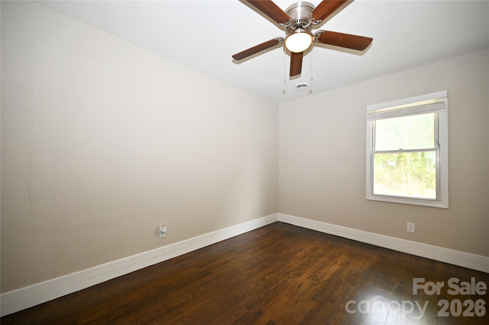 114 Gaston Street Chester, SC 29706 - Photo 11 of 15 an empty room with a window and wooden floor
