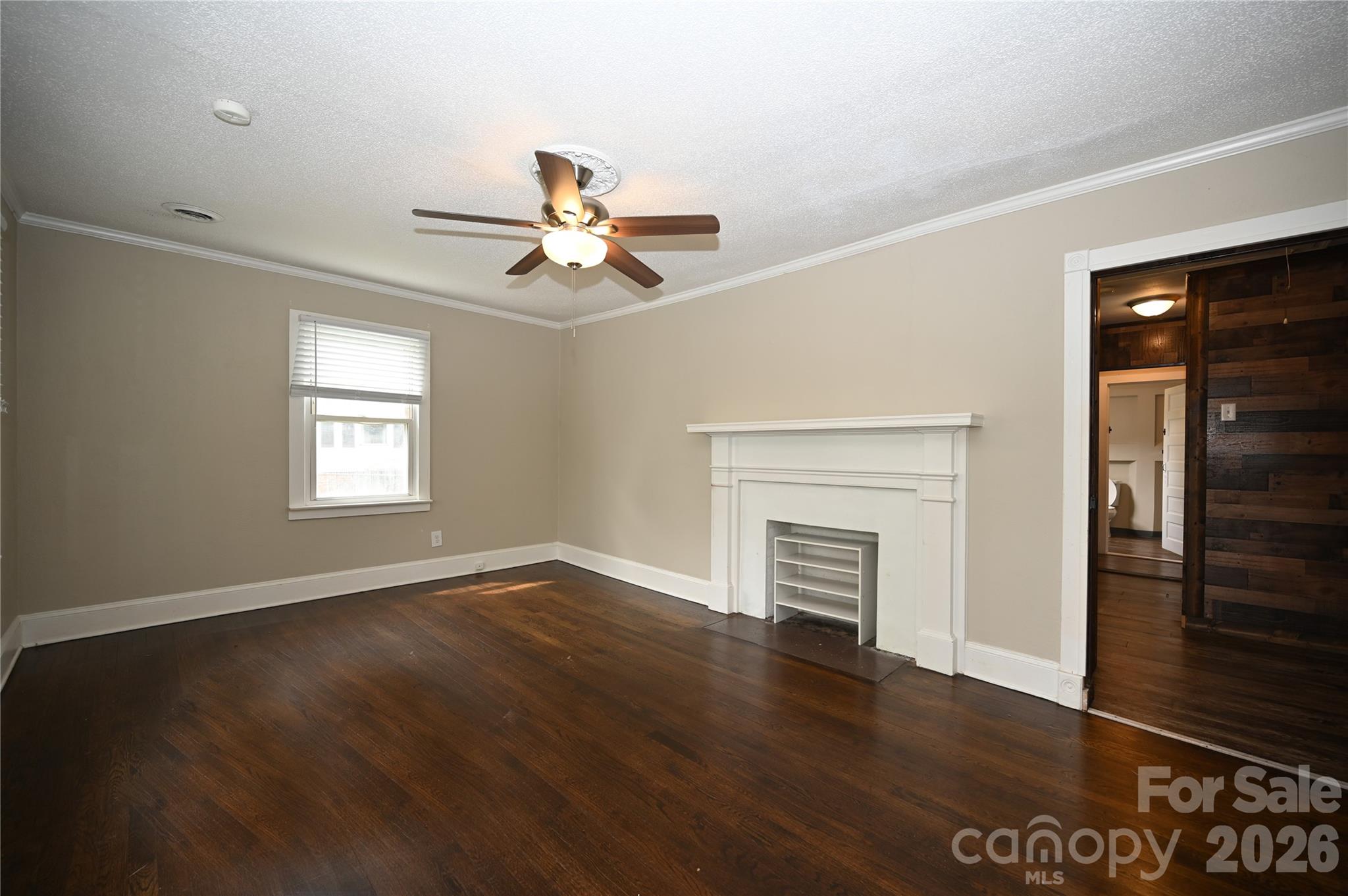 114 Gaston Street Chester, SC 29706 - Photo 4 of 15 an empty room with windows fireplace and wooden floor