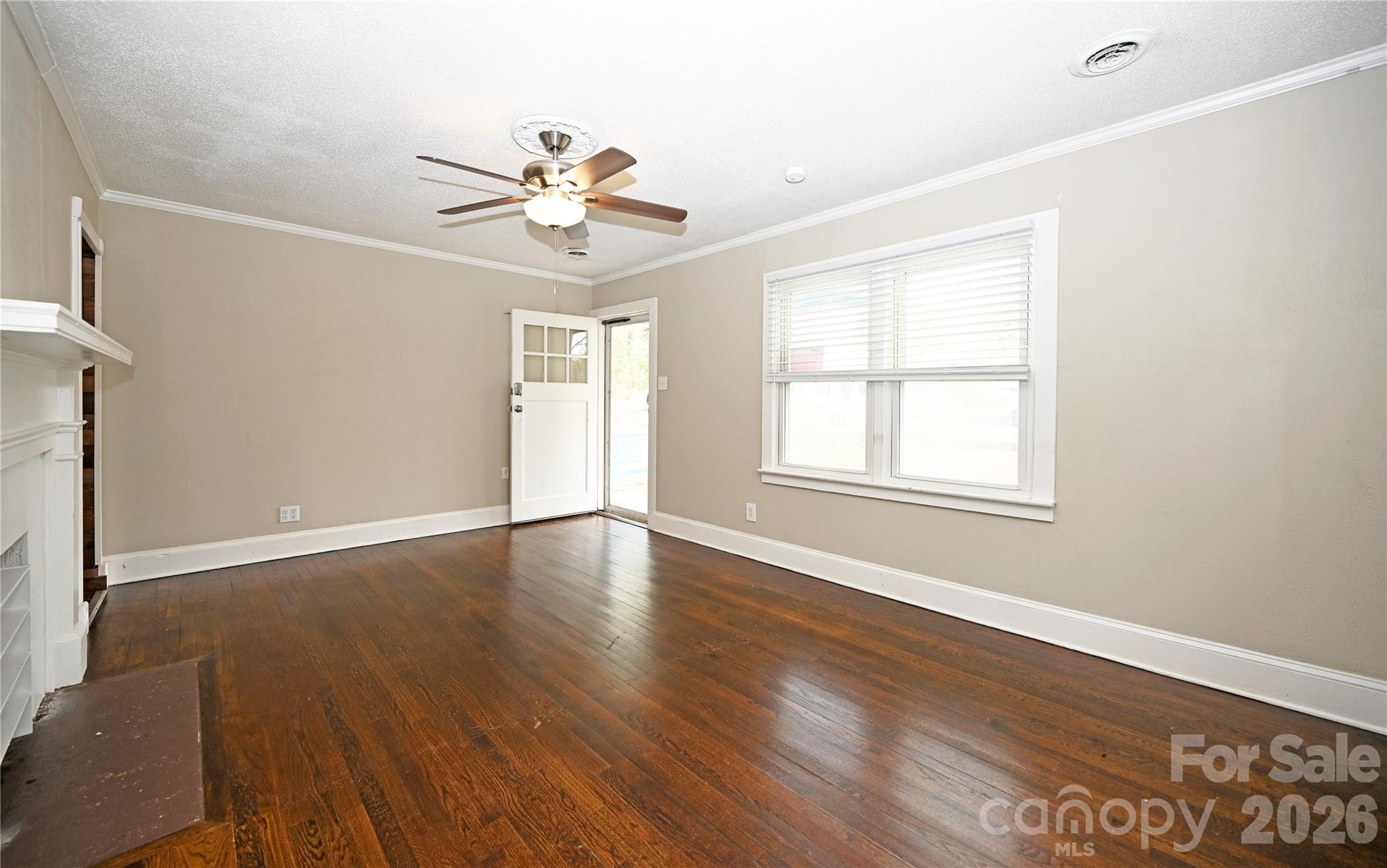 114 Gaston Street Chester, SC 29706 - Photo 5 of 15 a view of an empty room with wooden floor and a window