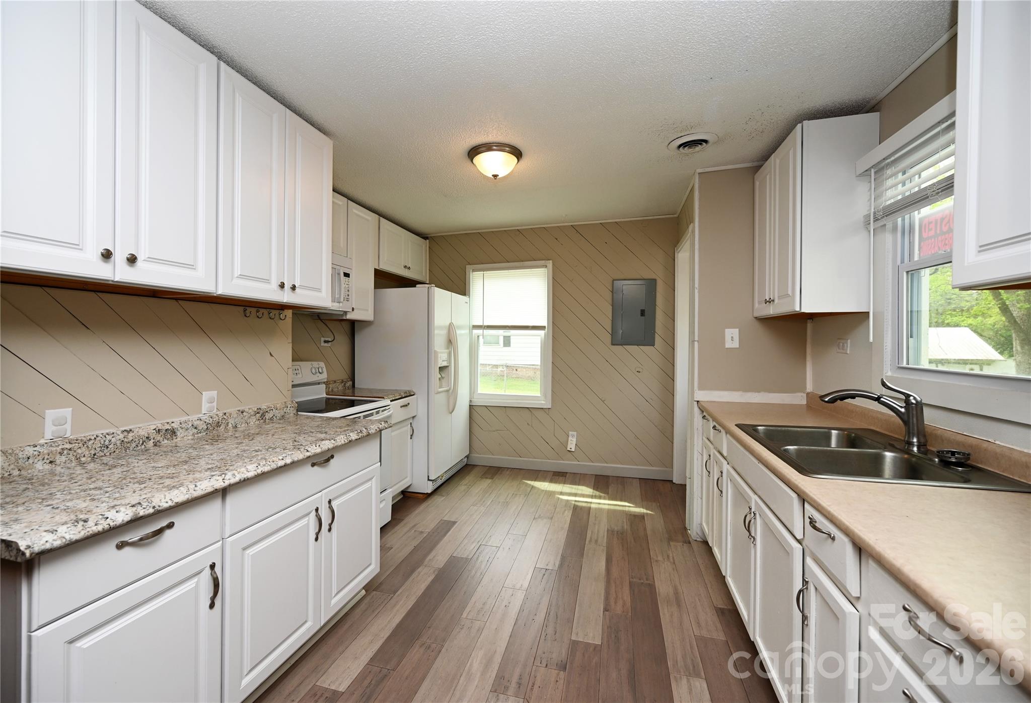 114 Gaston Street Chester, SC 29706 - Photo 6 of 15 a kitchen with granite countertop a sink a counter space stainless steel appliances and cabinets