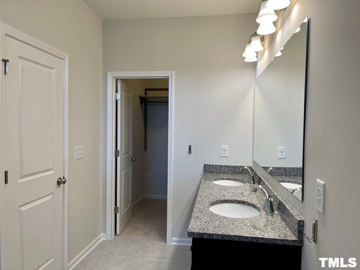 343 Great Northern Station Apex, NC 27502 - Photo 24 of 29 a bathroom with a granite countertop sink and a mirror