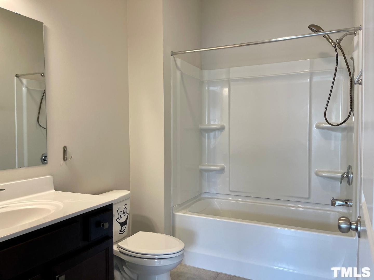 343 Great Northern Station Apex, NC 27502 - Photo 27 of 29 a bathroom with a granite countertop bathtub shower sink vanity and toilet