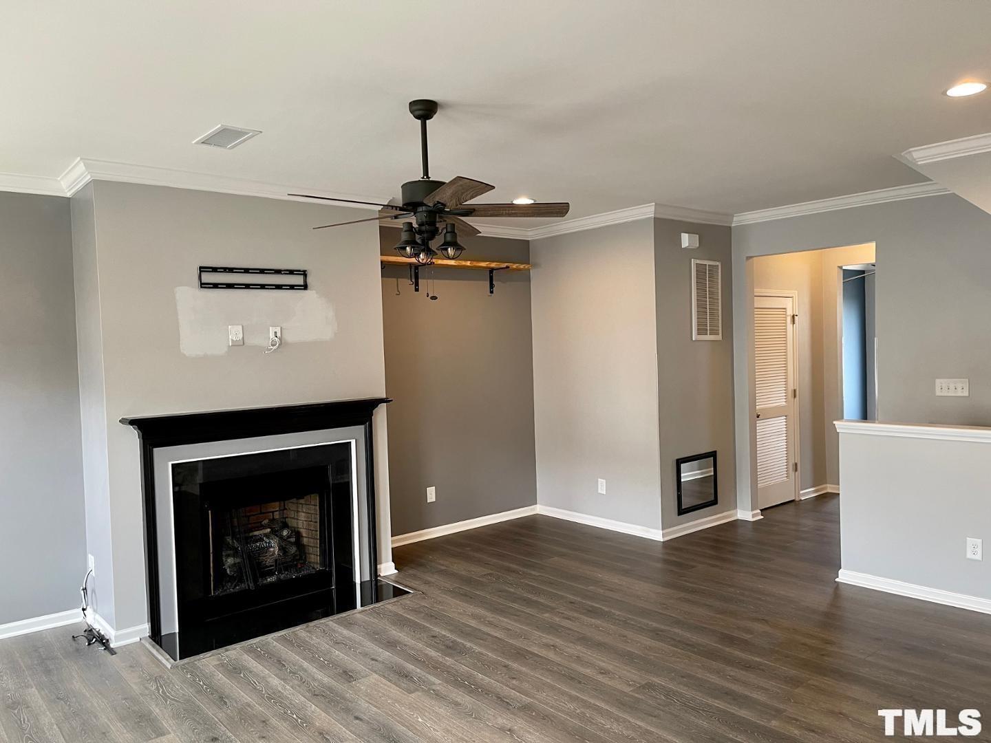 343 Great Northern Station Apex, NC 27502 - Photo 7 of 29 a view of an empty room with wooden floor and a fireplace