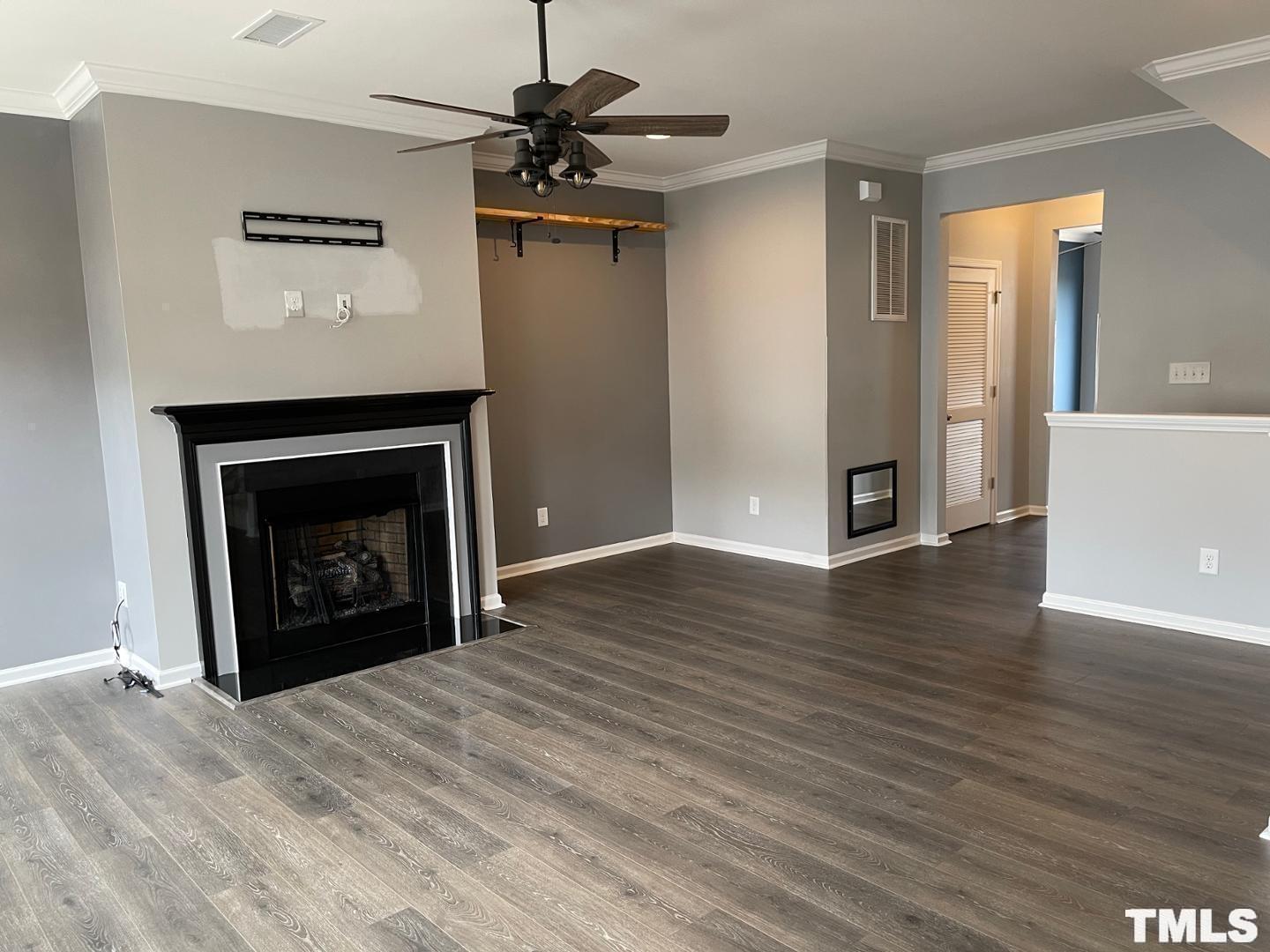 343 Great Northern Station Apex, NC 27502 - Photo 8 of 29 a view of an empty room with wooden floor and a fireplace