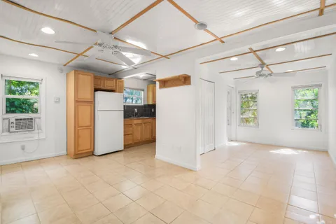 an empty room with windows and entrance