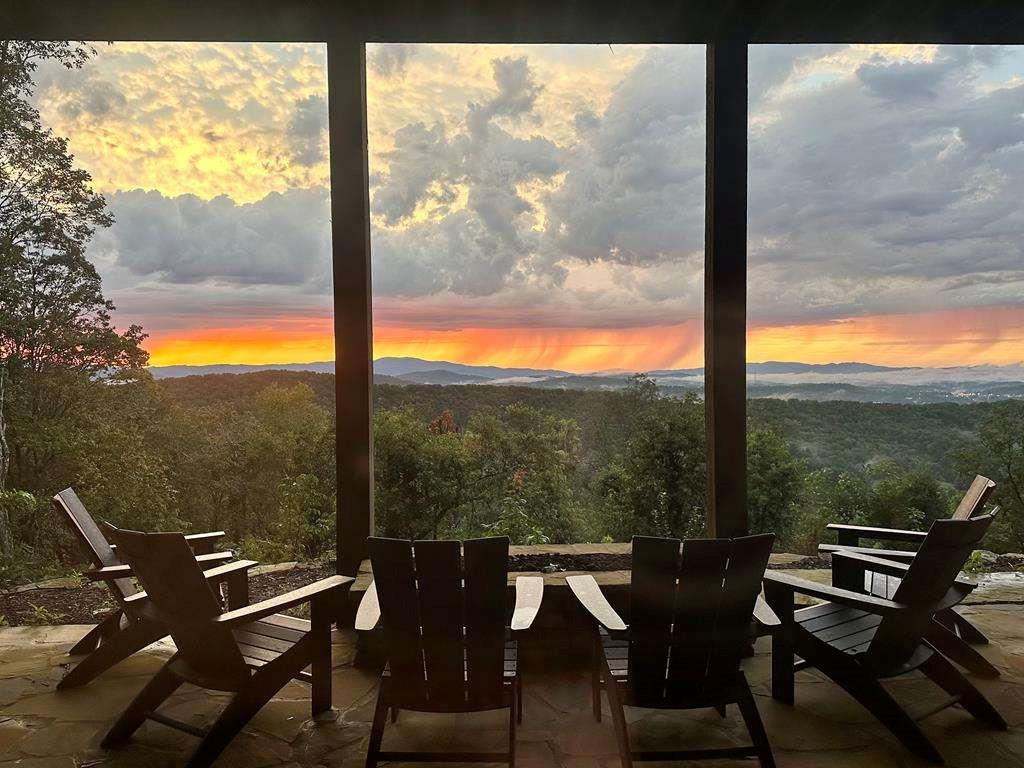 a view of a mountain from a table and chairs in patio