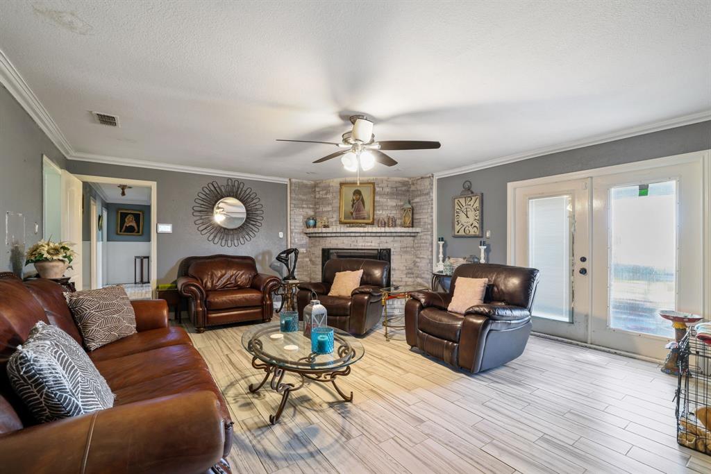 12475 Fm 2728 Terrell, TX 75161 - Photo 13 of 27 a living room with furniture a fireplace and a large window