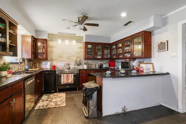 a kitchen with a sink cabinets and window