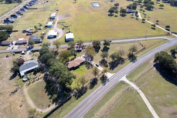 an aerial view of a house with a yard and lake view