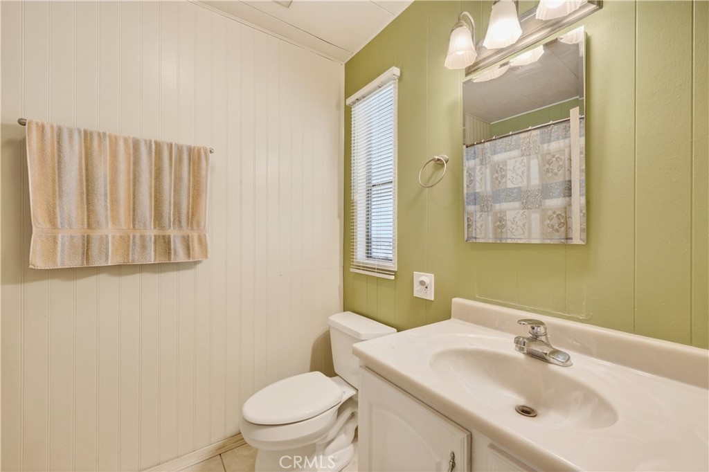 1001 East Lambert Road, Unit 258 La Habra, CA 90631 - Photo 26 of 75 a bathroom with a sink a toilet and mirror