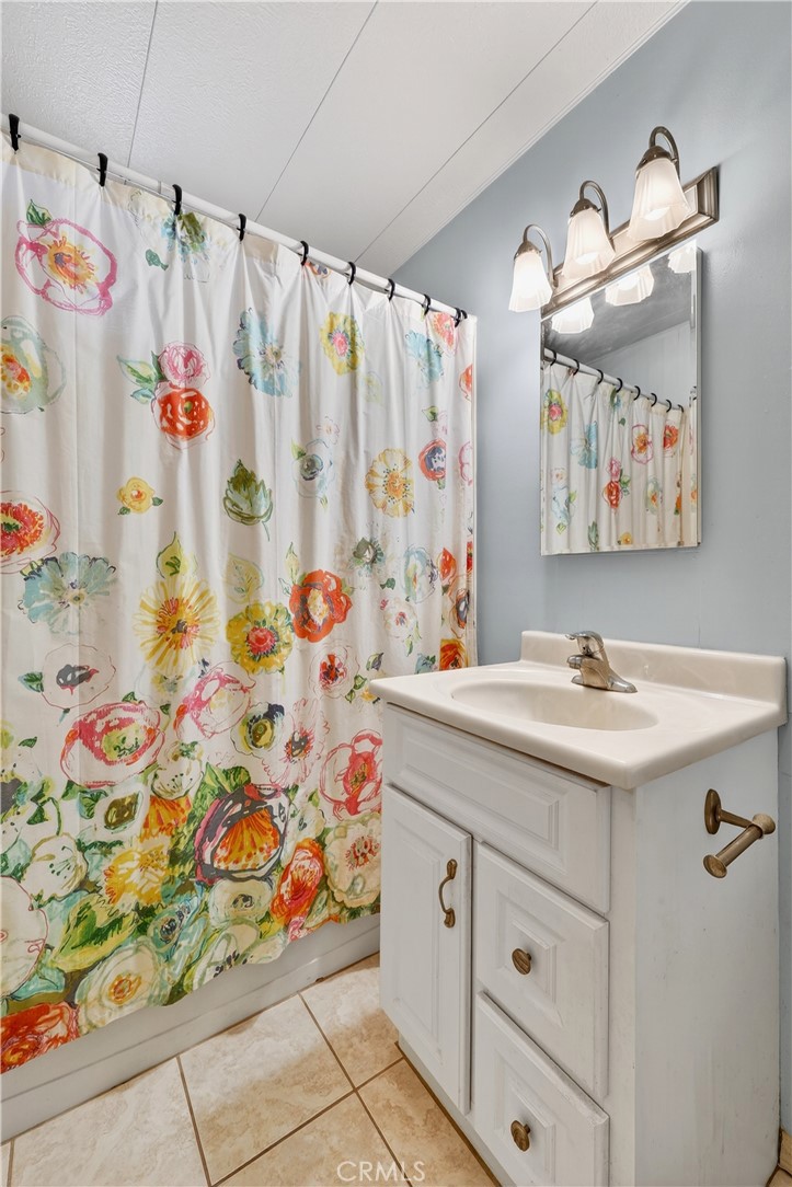 1001 East Lambert Road, Unit 258 La Habra, CA 90631 - Photo 31 of 75 a bathroom with a sink and a shower curtain