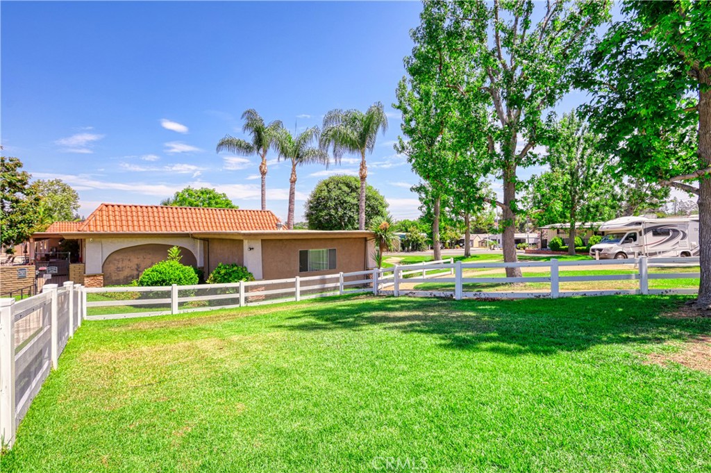 1001 East Lambert Road, Unit 258 La Habra, CA 90631 - Photo 61 of 75 a view of a house with a big yard potted plants and a large tree