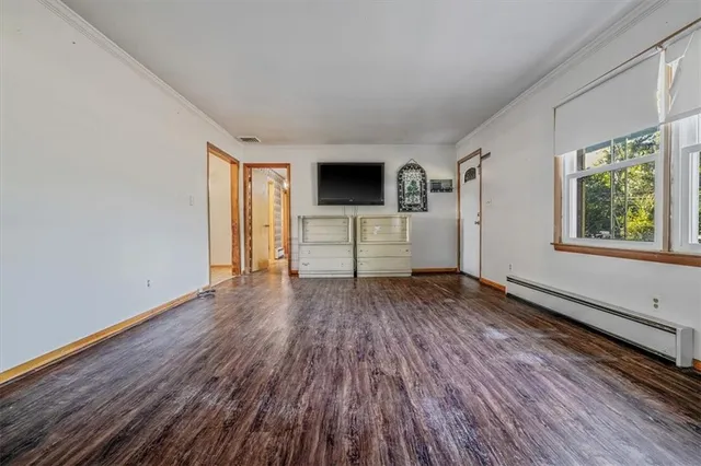 a view of a livingroom with wooden floor and window