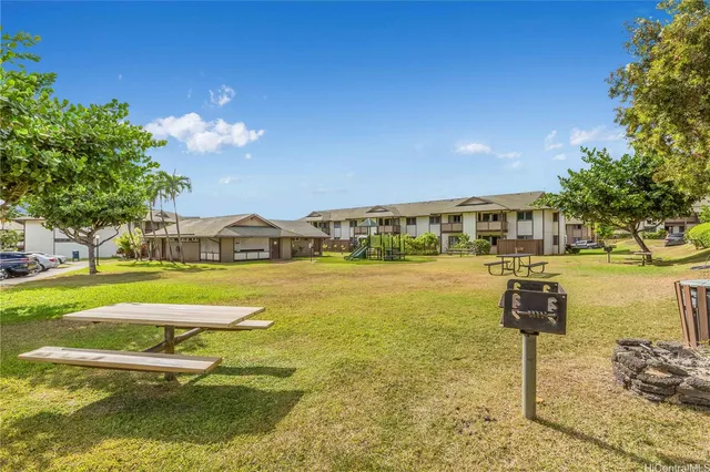 a view of a cars park in front of a building