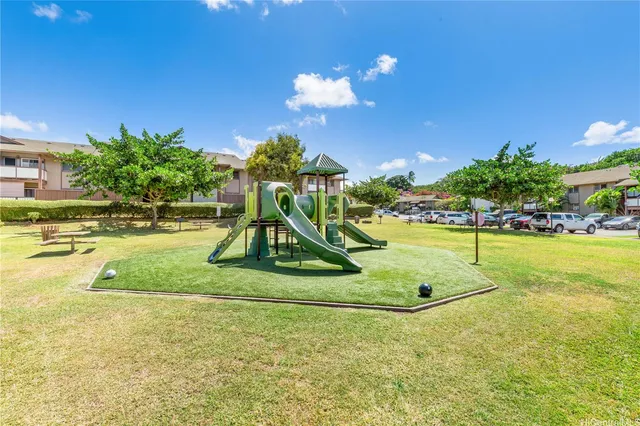 a view of a big house with a big yard and large trees