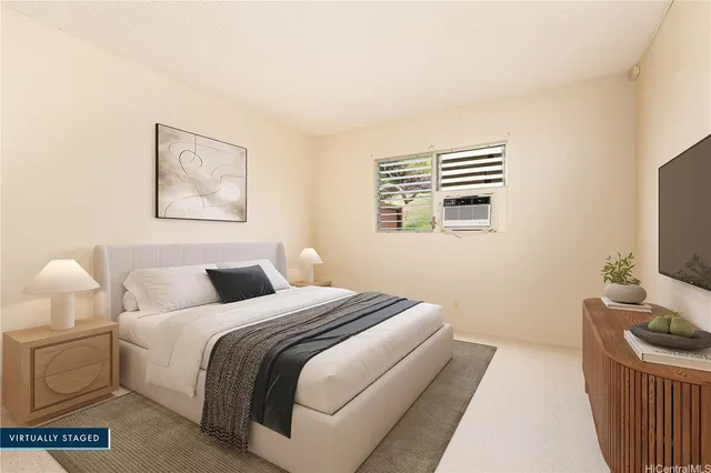 a bedroom with a bed and a flat screen tv