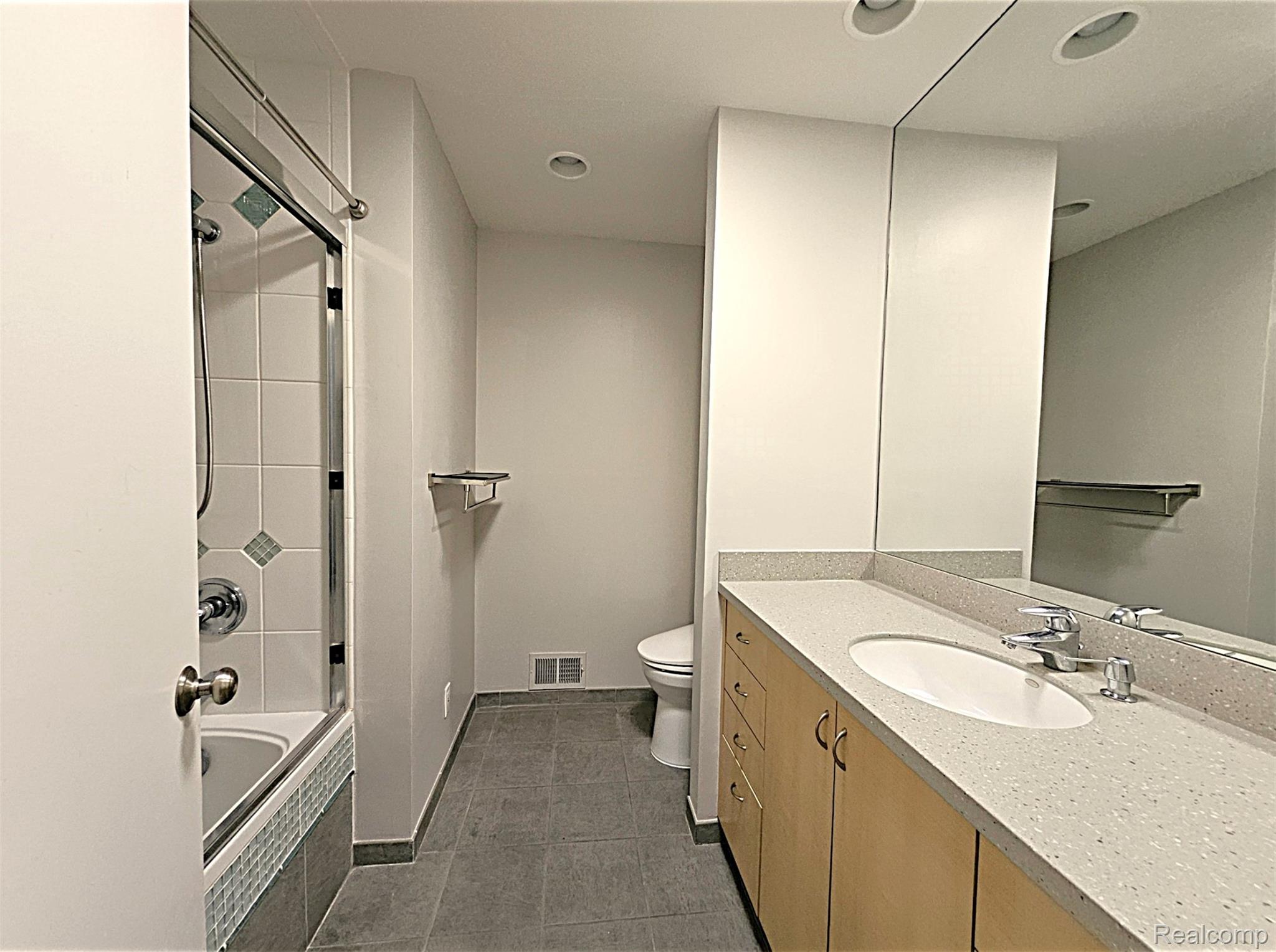 7120 Pebblecreek Road West Bloomfield, MI 48322 - Photo 26 of 31 Bathroom featuring a full vanity with light-wood cabinetry, a light-toned countertop, and an integrated sink