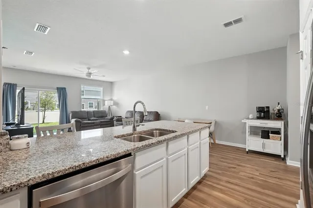 a kitchen with granite countertop a sink and a stove