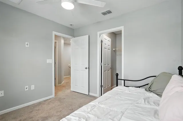 a bedroom with a bed and a mirror