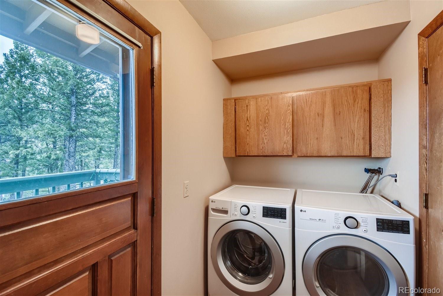25756 Zugspitz Road Evergreen, CO 80439 - Photo 23 of 31 a utility room with dryer and washer