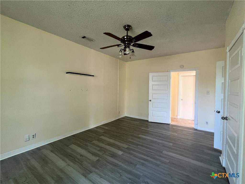 902 North 1st Street Temple, TX 76501 - Photo 13 of 29 a view of a livingroom with a hardwood floor and a ceiling fan