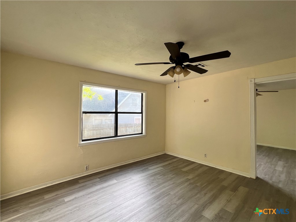 902 North 1st Street Temple, TX 76501 - Photo 15 of 29 an empty room with wooden floor and windows