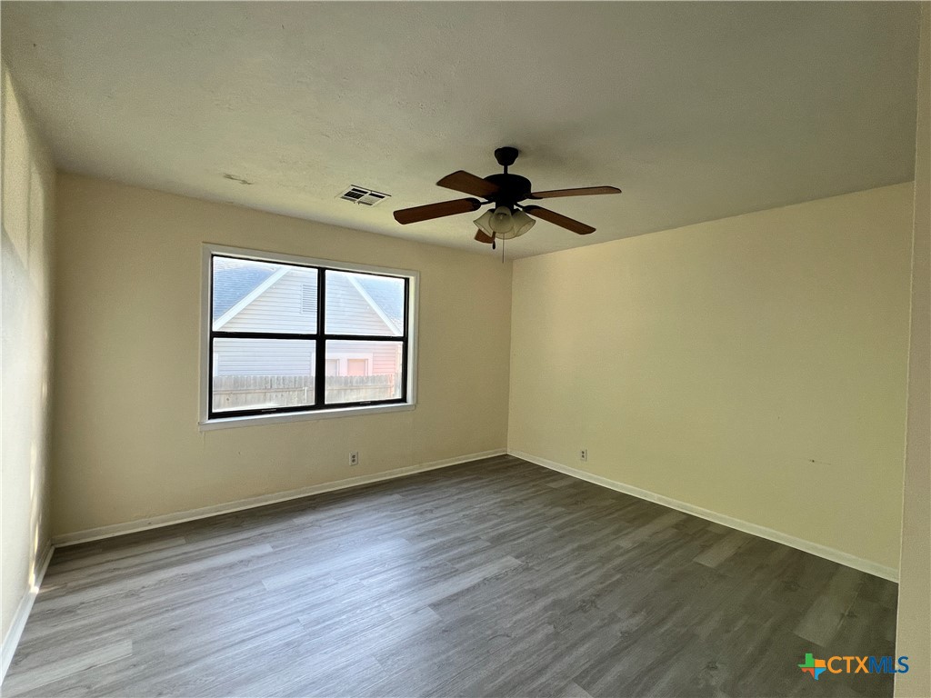902 North 1st Street Temple, TX 76501 - Photo 17 of 29 wooden floor in an empty room with a window