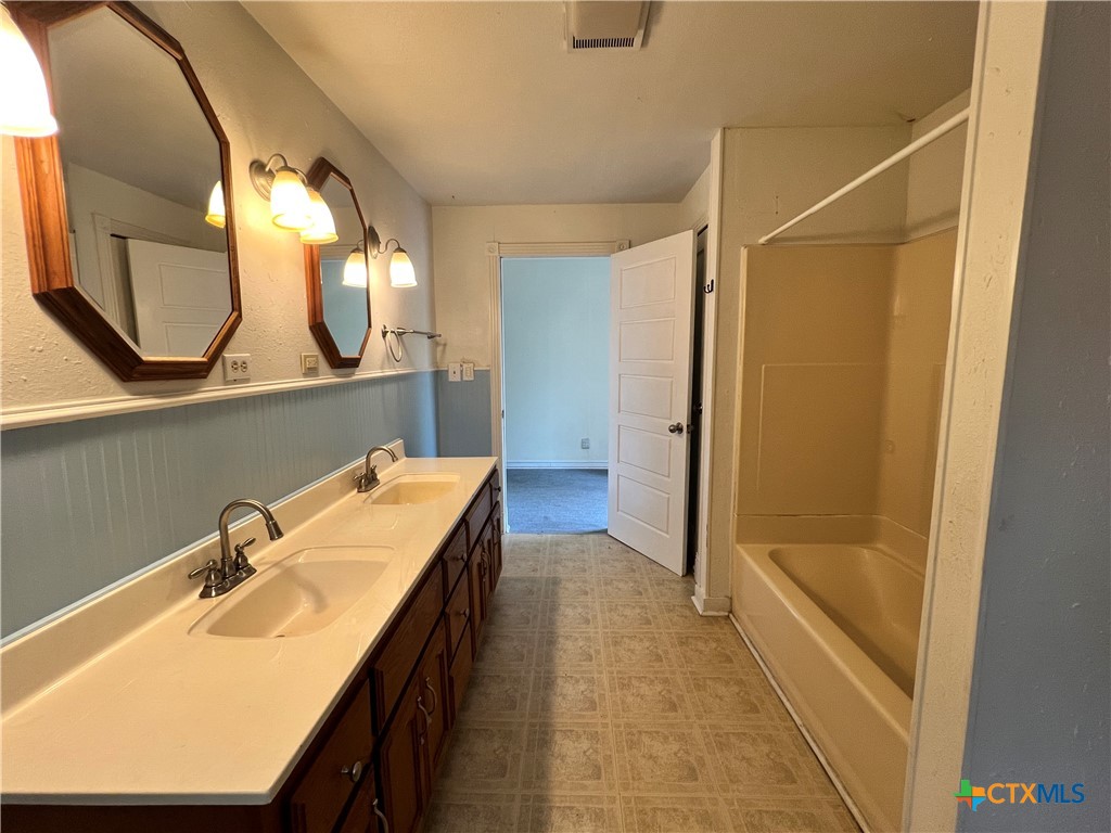 902 North 1st Street Temple, TX 76501 - Photo 20 of 29 a bathroom with a sink and a mirror