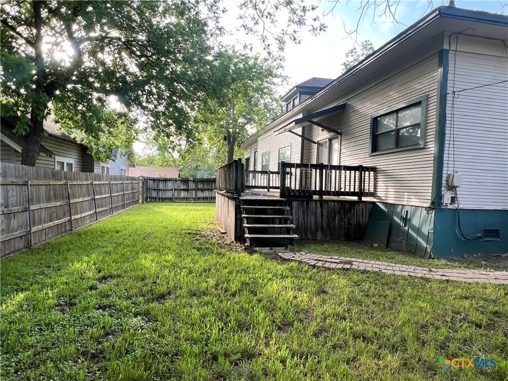 902 North 1st Street Temple, TX 76501 - Photo 29 of 29 a view of a backyard with a small cabin and wooden fence