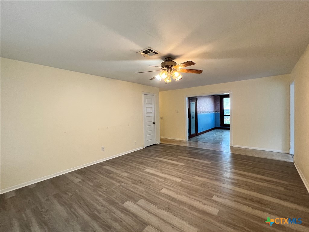 902 North 1st Street Temple, TX 76501 - Photo 6 of 29 an empty room with wooden floor and windows
