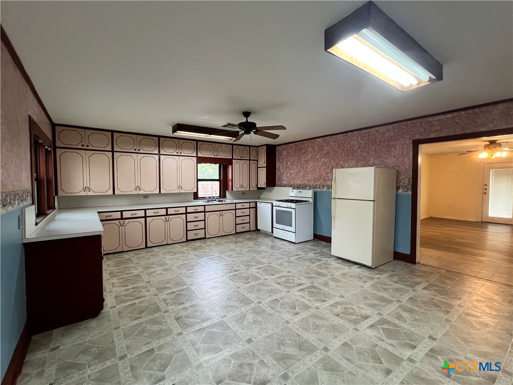 902 North 1st Street Temple, TX 76501 - Photo 8 of 29 a kitchen with refrigerator and cabinets