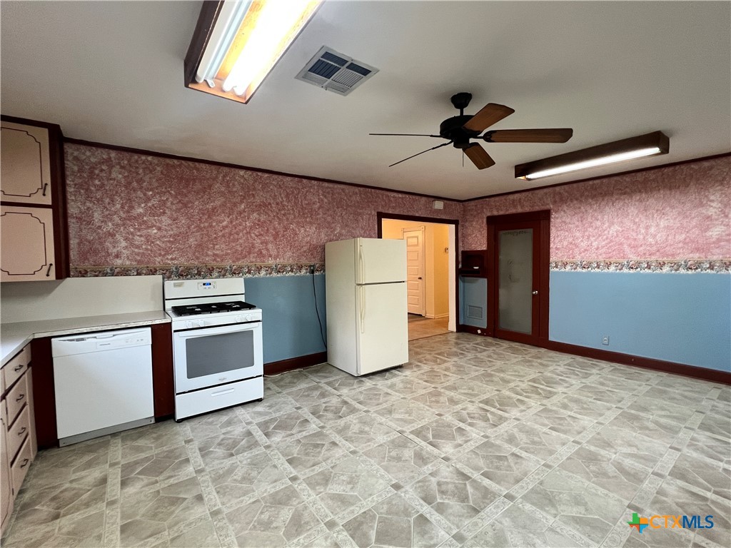 902 North 1st Street Temple, TX 76501 - Photo 9 of 29 a view of a kitchen with a stove cabinets and a ceiling fan