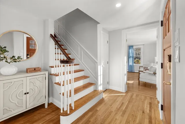a view of a hallway with wooden floor and dining room