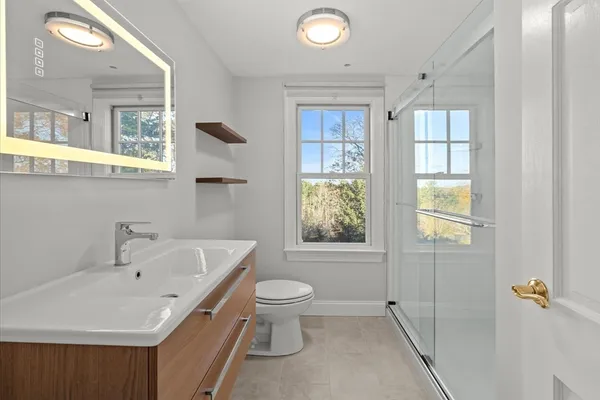 a bathroom with a sink toilet and shower
