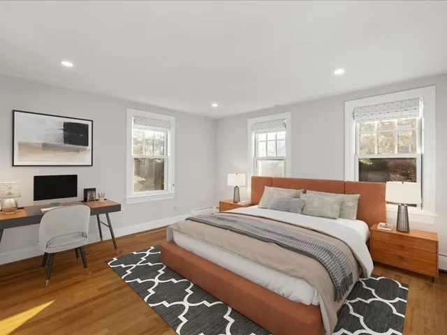 a bedroom with a bed a table and chair