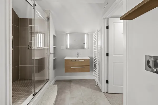 a bathroom with a shower and a sink