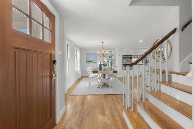 a view of an entryway with wooden floor and windows