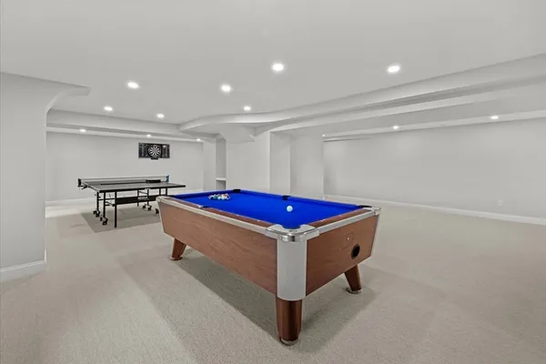 a room with pool table and a projector screen