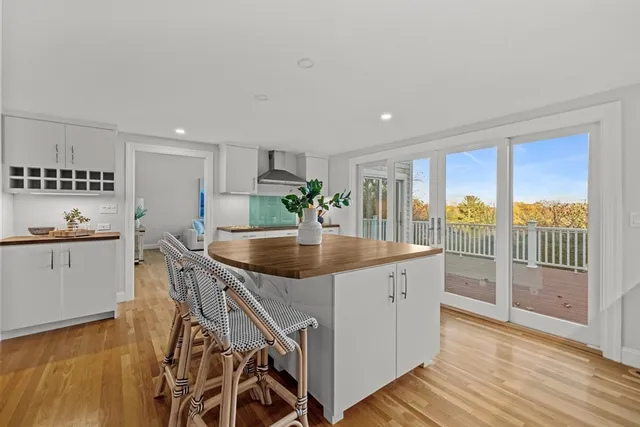 a kitchen with stainless steel appliances granite countertop a sink a stove and a wooden floors