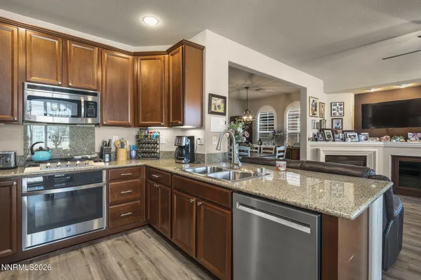 a kitchen with stainless steel appliances granite countertop a stove sink microwave and cabinets