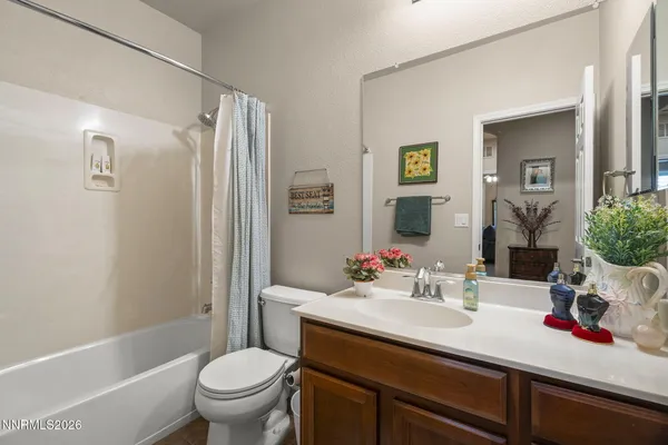 a bathroom with a sink toilet vanity and shower