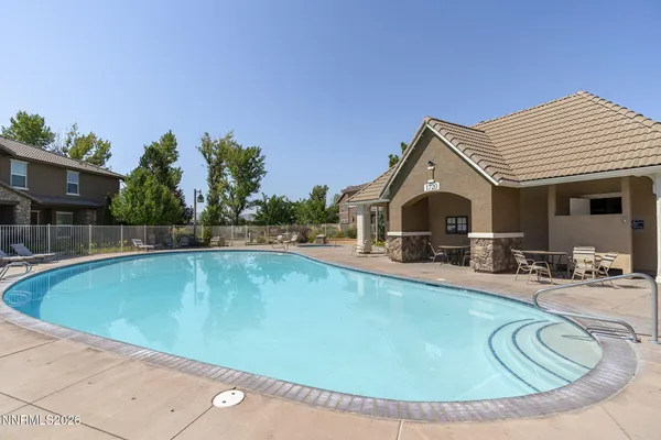 a view of a house with swimming pool and sitting area