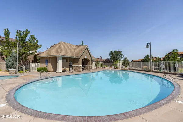 a view of a swimming pool with a bench in front of it