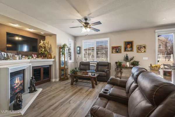 a living room with furniture a flat screen tv and a fireplace