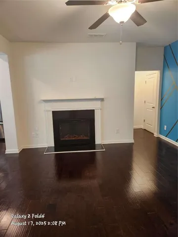 an empty room with wooden floor and fireplace