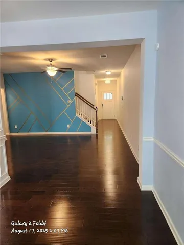 a view of an empty room with wooden floor